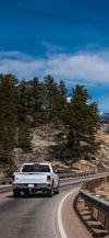 Pickup driving through the Rocky Mountains
