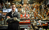 Mechanic stands in messy workshop