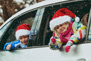 Kids in Christmas Hats in snowy car