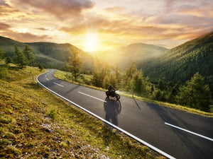 Motorcycle and rider cruise a mountain pass