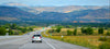 Car coasts down hill on long open road