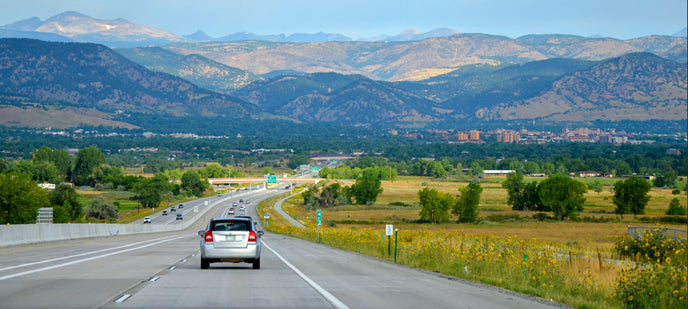 Car coasts down hill on long open road