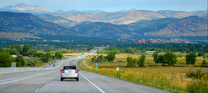 Car coasts down hill on long open road