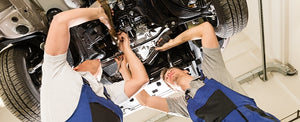 Mechanics working under car