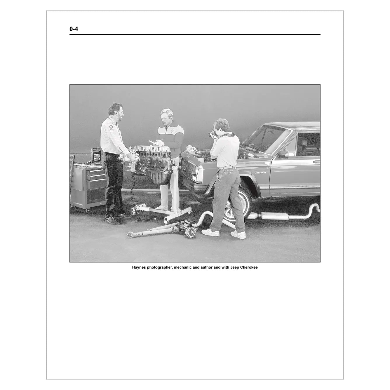 Black and white photo of three men working on a car engine with text at the bottom.